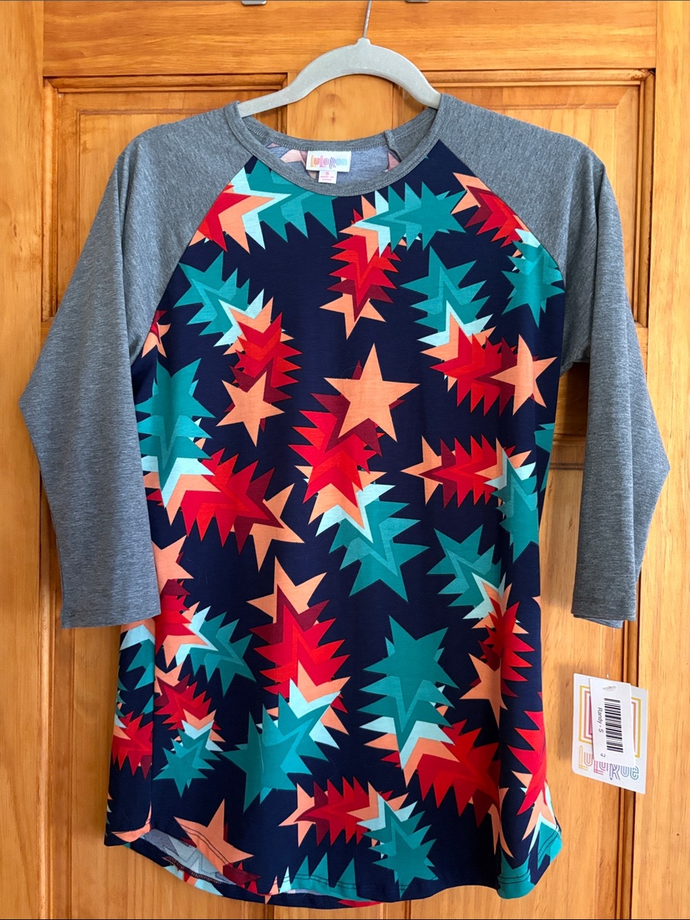 LuLaRoe Navy Starburst Raglan with Teal, Coral & Red Accents